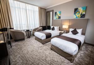 Postel nebo postele na pokoji v ubytování Aquila ALdiafah Hotel