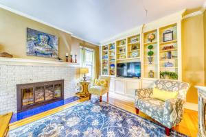 a living room with a fireplace and a chair at The Harrison House in Boise