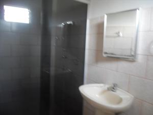 a bathroom with a sink and a shower at Pousada Estrela Matutina in Pirenópolis