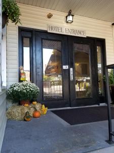a hotel entrance with a bunch of pumpkins in front at Mainstay Inn in Phoenixville