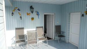 a room with chairs and kites on the wall at Willa Victoria in Ciechocinek