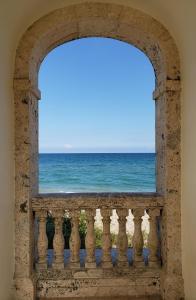 a window with a view of the ocean at Hemingway Suites at Palm Beach Hotel Island in Palm Beach