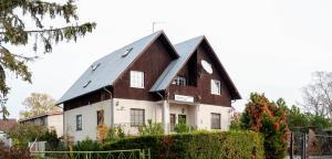 a brown and white house with a black roof at Cinnamon villa in Palanga