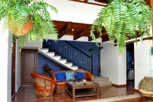 a living room with a couch and a staircase at Casa Santa Lucia in San Cristóbal de Las Casas