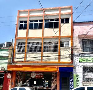 a tall building with windows on a city street at Hotel Fortaleza III Manaus in Manaus