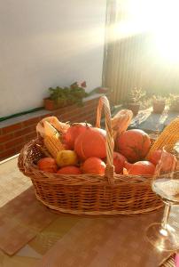 a basket of fruit and vegetables on a table at CASA SPERANTEI in Sighişoara +20 photos