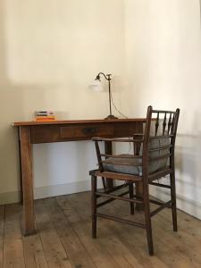 a wooden desk with a chair and a lamp on it at Studio Minerva in Antwerp