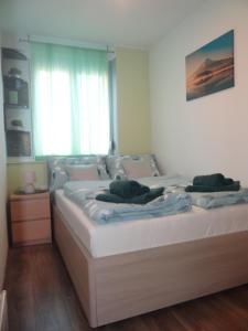 a bedroom with a bed with two towels on it at Apartman Anja in Karlovac