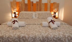 two beds with pillows and towels on them at Twenty Seven Degrees Las Palmas in Las Palmas de Gran Canaria