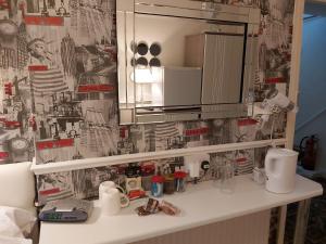 a bathroom with a counter with a sink and a mirror at A&P at The Sheron House in Blackpool