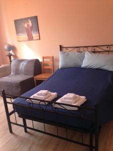 a bedroom with a bed with two towels on it at Il Giardino Nel Parco R&B in Bologna