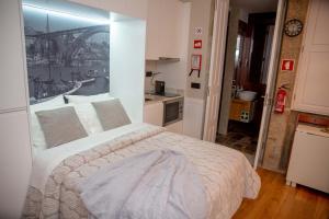 a bedroom with a bed with a view of a bridge at Oporto Ana's Studio in Porto