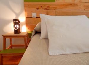 a bed with a white comforter and pillows at Twenty Seven Degrees Las Palmas in Las Palmas de Gran Canaria