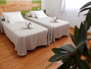 a hotel room with two beds and a table at Twenty Seven Degrees Las Palmas in Las Palmas de Gran Canaria