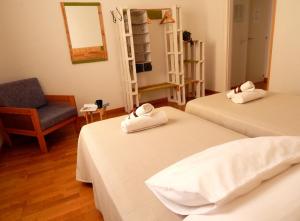 a white bed sitting in a bedroom next to a window at Twenty Seven Degrees Las Palmas in Las Palmas de Gran Canaria