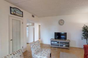 a living room with a couch and a tv at Ventura Condominiums #204 in South Padre Island