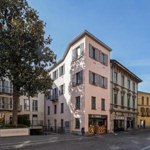 a tall white building on a city street at 30Cavour luxury suites in Pavia