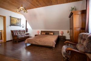 a bedroom with a bed and a couch at Hájovna Hněvnice in Hněvnice