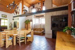 a living room with a wooden table and a fireplace at Hájovna Hněvnice in Hněvnice