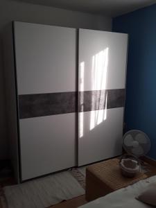 a bedroom with a large white and gray sliding door at La Maison d'Alruna in Beauchalot