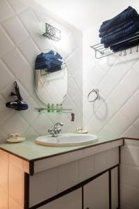 a bathroom with a sink and a mirror at Casa Arvana Near Calangute Beach in Calangute