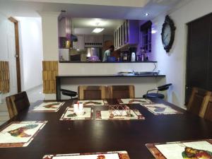 a room with a table with chairs and a kitchen at LEONE PARIS in Windhoek