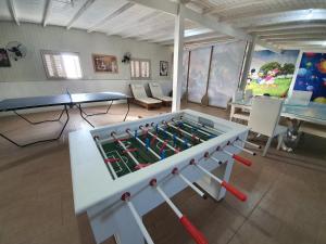 a room with a large foosball table in it at Pousada do Primo in Capão da Canoa