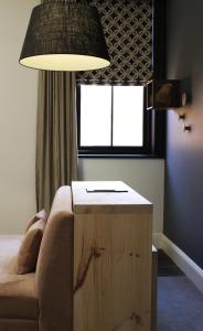 a lamp sitting on top of a wooden chair in a living room at Perry Street Hotel in Mudgee