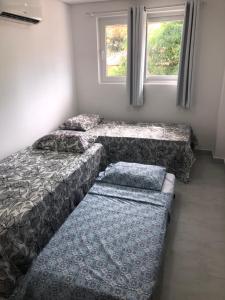a small room with a bed and a couch at Makaiba Residence Flat dr Artur Licio in Porto De Galinhas