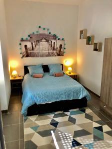 a bedroom with a bed with a picture of a bridge at NOUVEAU : Le puits de Sarlat in Sarlat-la-Canéda