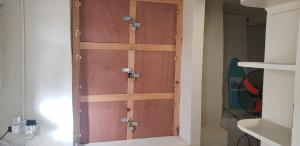 un paio di porte in legno in un armadio di Roseau Hostel & Beach Front Property a Roseau