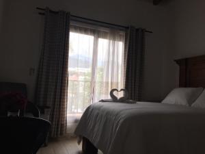 Postel nebo postele na pokoji v ubytování Hotel Concierge Flor y Canto