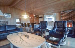 SpodsbjergにあるPet Friendly Home In Rudkbing With Outdoor Swimming Poolのリビングルーム(テーブル、革張りの椅子付)