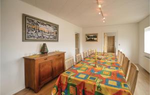 a dining room with a table and chairs in a room at Cozy Home In Thyholm With Kitchen in Thyholm