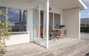 a patio with a table and chairs on a house at Three-Bedroom Holiday Home In Haderslev in Haderslev