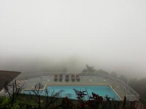 a swimming pool in the middle of a foggy mountain at Green View Holiday Resort in Elkaduwa
