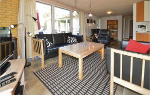a living room with a couch and a coffee table at 3 Bedroom Amazing Home In Fars in Hvalpsund