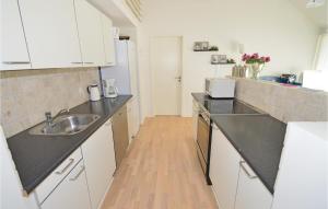 a kitchen with a sink and a counter top at Awesome Home In Brovst With 3 Bedrooms, Sauna And Wifi in Brovst