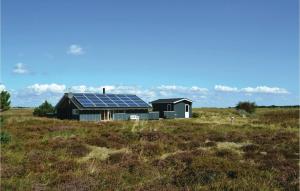 a house with solar panels on it in a field at Holiday Home Bjerges Leje Fanø Iv in Sønderho