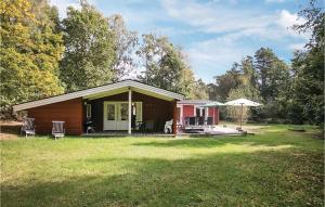 a small house with a porch and a patio at Holiday Home Brogårdsvejen Nexø X in Bedegård
