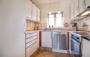 a kitchen with a sink and a dishwasher at Holiday Home Horns Bjerge Blåvand Iv in Blåvand