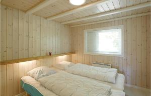 a bedroom with two beds in a room with a window at Holiday Home Turistvej Nexø in Snogebæk