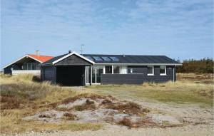 a black house with solar panels on top of it at 3 Bedroom Nice Home In Harbore in Harboør