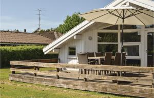 a deck with a table and an umbrella at Stunning Home In Humble With Wifi in Humble