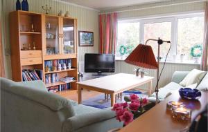 a living room with a couch and a table at Beautiful Home In Roslev With 2 Bedrooms in Glyngøre