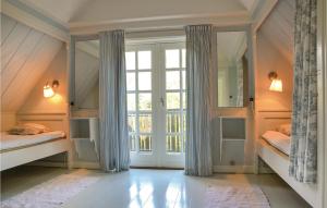 a room with two bunk beds and a large window at Two-Bedroom Holiday Home In Hornbak in Hornbæk