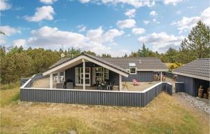 a house with a large deck in a yard at 3 Bedroom Gorgeous Home In Blvand in Blåvand