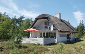 RødhusにあるNice Home In Pandrup With 3 Bedrooms And Wifiの傘付きの茅葺き屋根の家