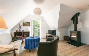 a living room with a couch and a wood stove at Awesome Apartment In Nex With Kitchen in Neksø