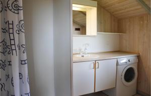 a bathroom with a sink and a washing machine at Nice Home In Kirke Hyllinge With Wifi in Kirke-Hyllinge